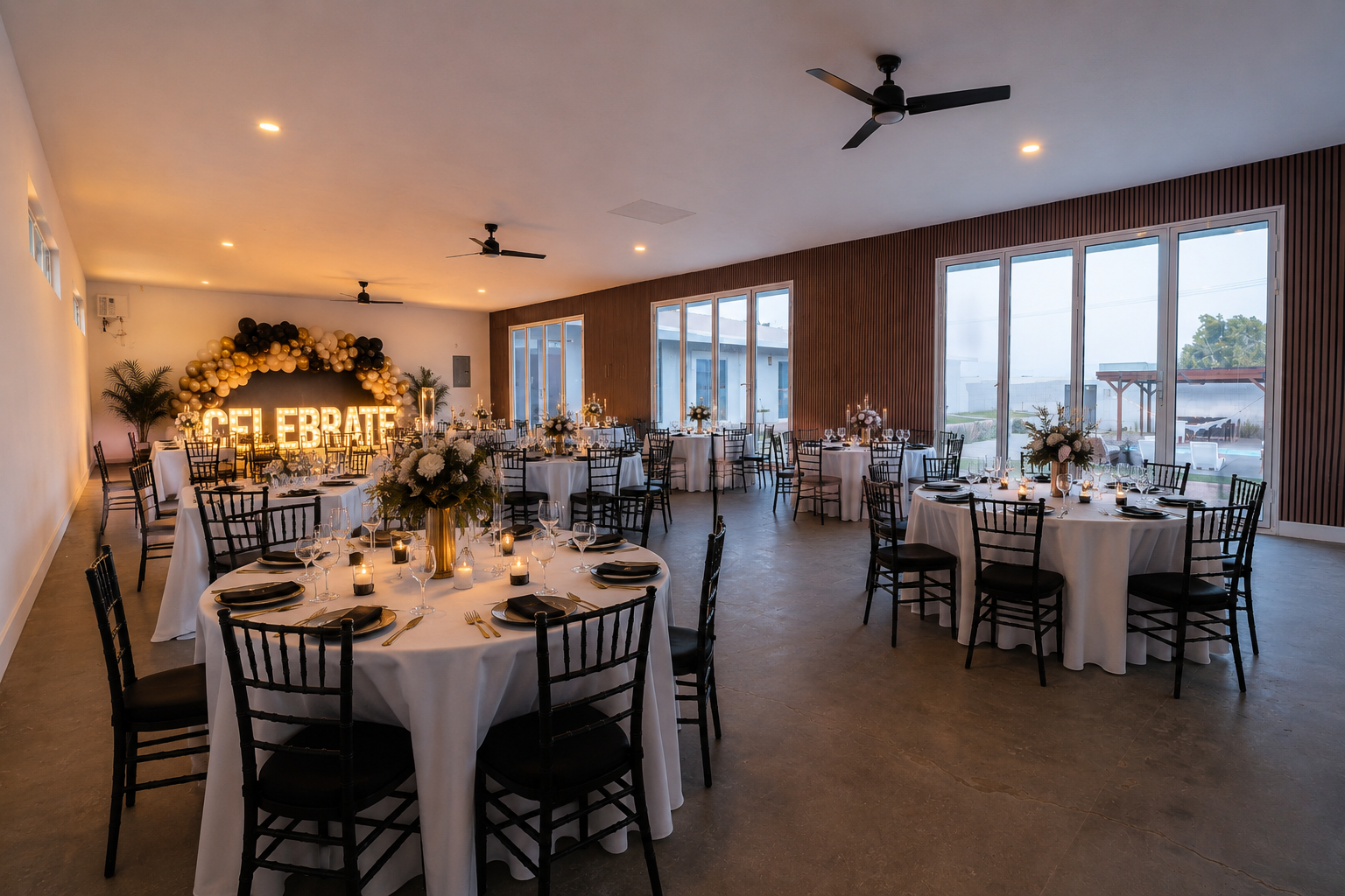 A podcast recording venue rental setup inside a private desert estate event space with Mojave landscape visible through large windows and warm afternoon light